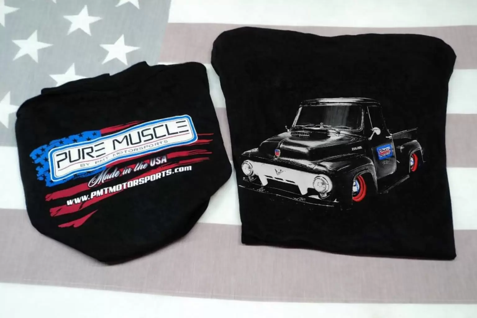 Two black T?shirts laid flat: one with a 'PURE MUSCLE' logo and red?white?blue flag graphic, the other featuring a vintage black pickup truck illustration.